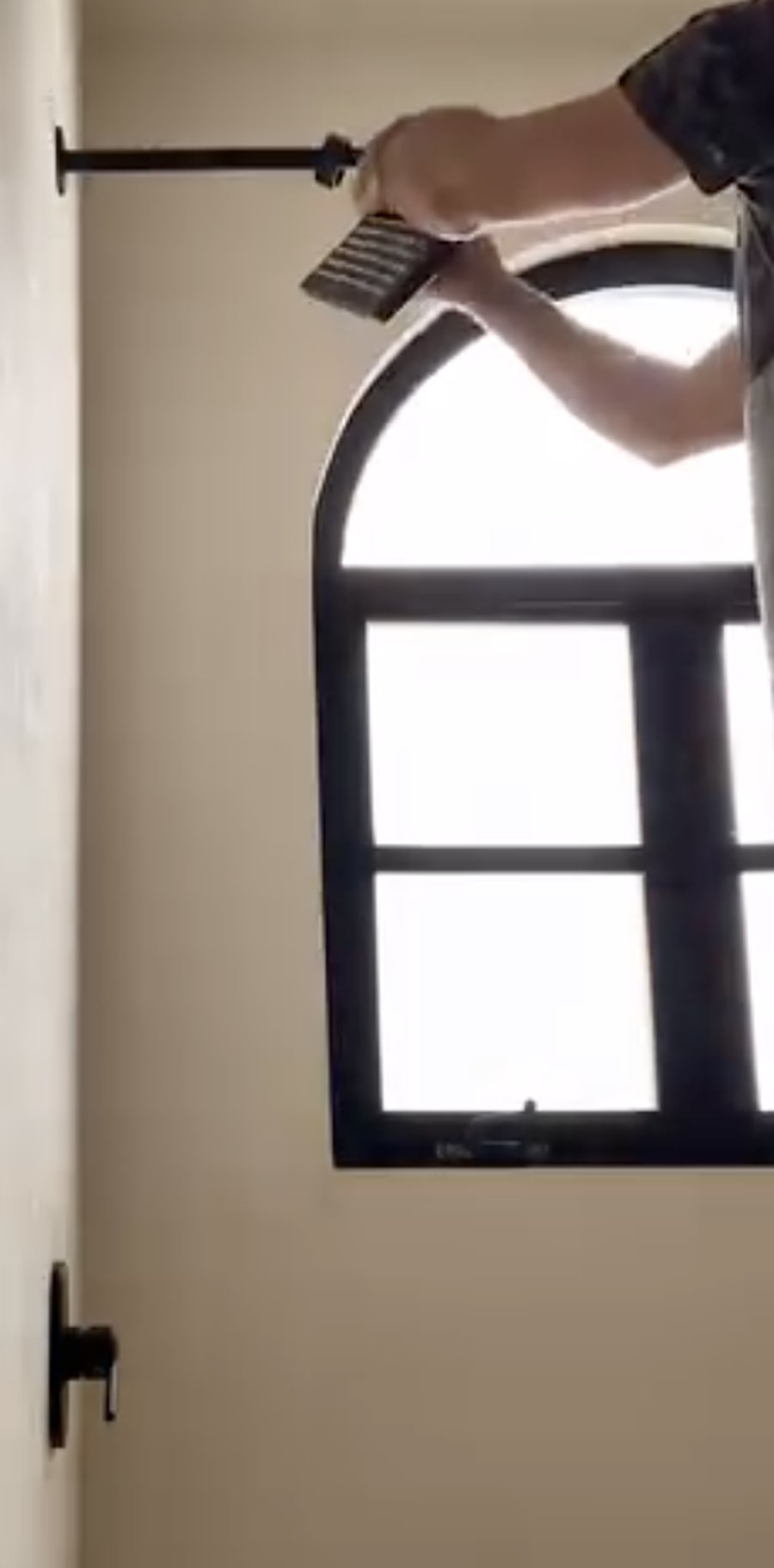 Arched window with black frame in a Tulum property
