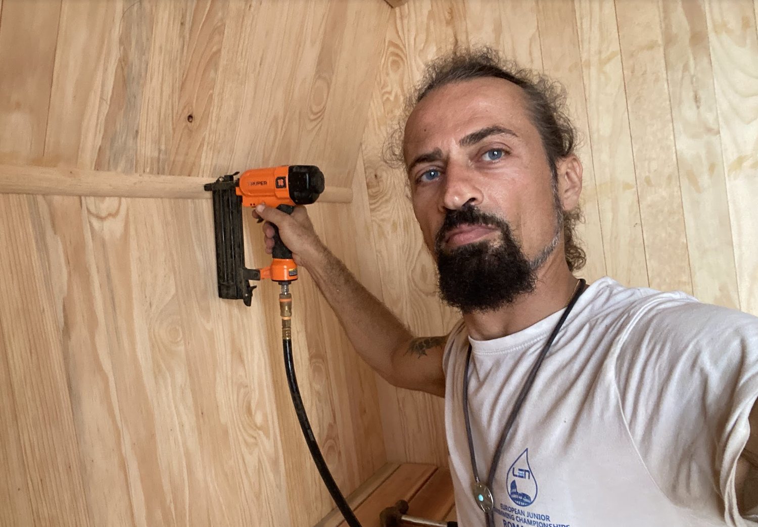 Cedar lining being installed inside a custom-built sauna