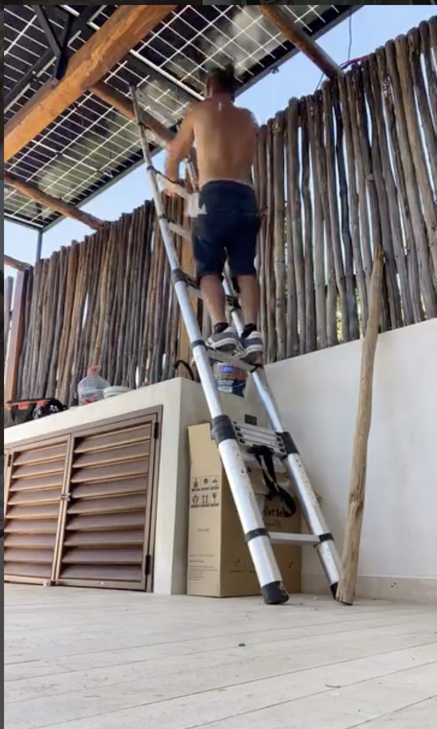 Solar panels being installed on a rooftop structure
